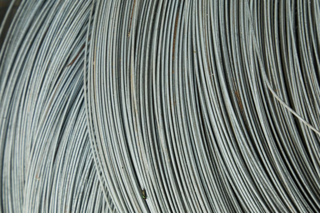 Abstract background of thin fragile white many wires placed chaotically in rows and lines