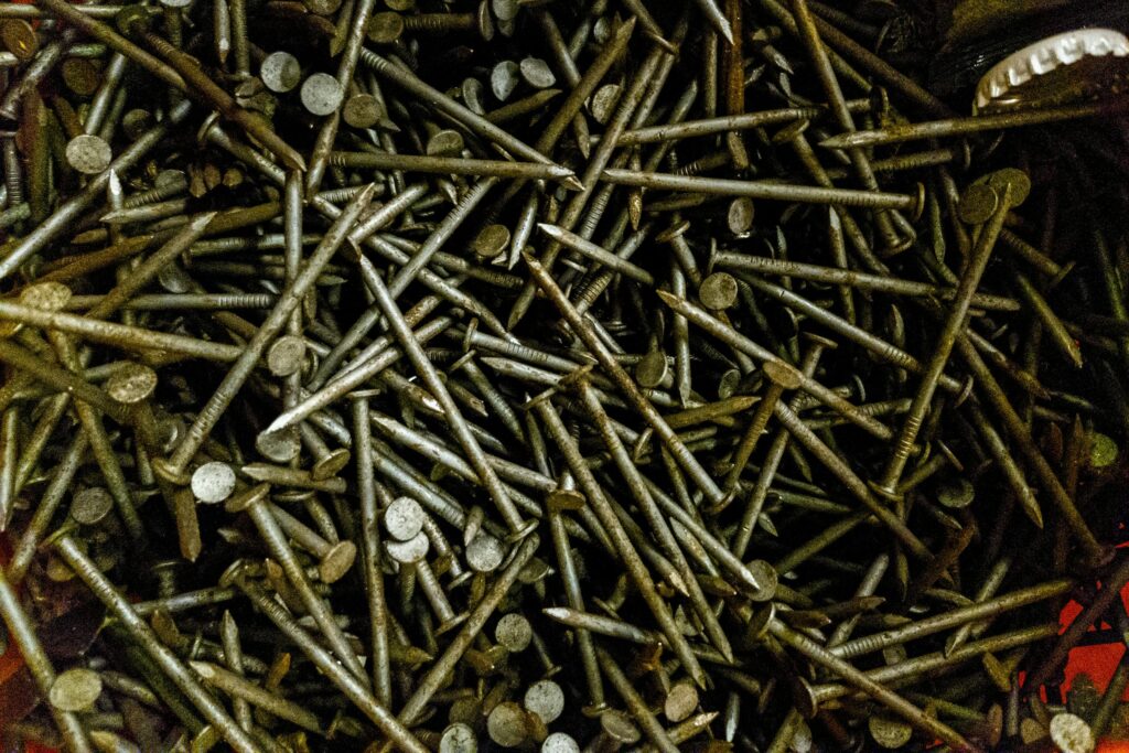 Close-up of scattered rusty nails showcasing industrial texture and aesthetic.