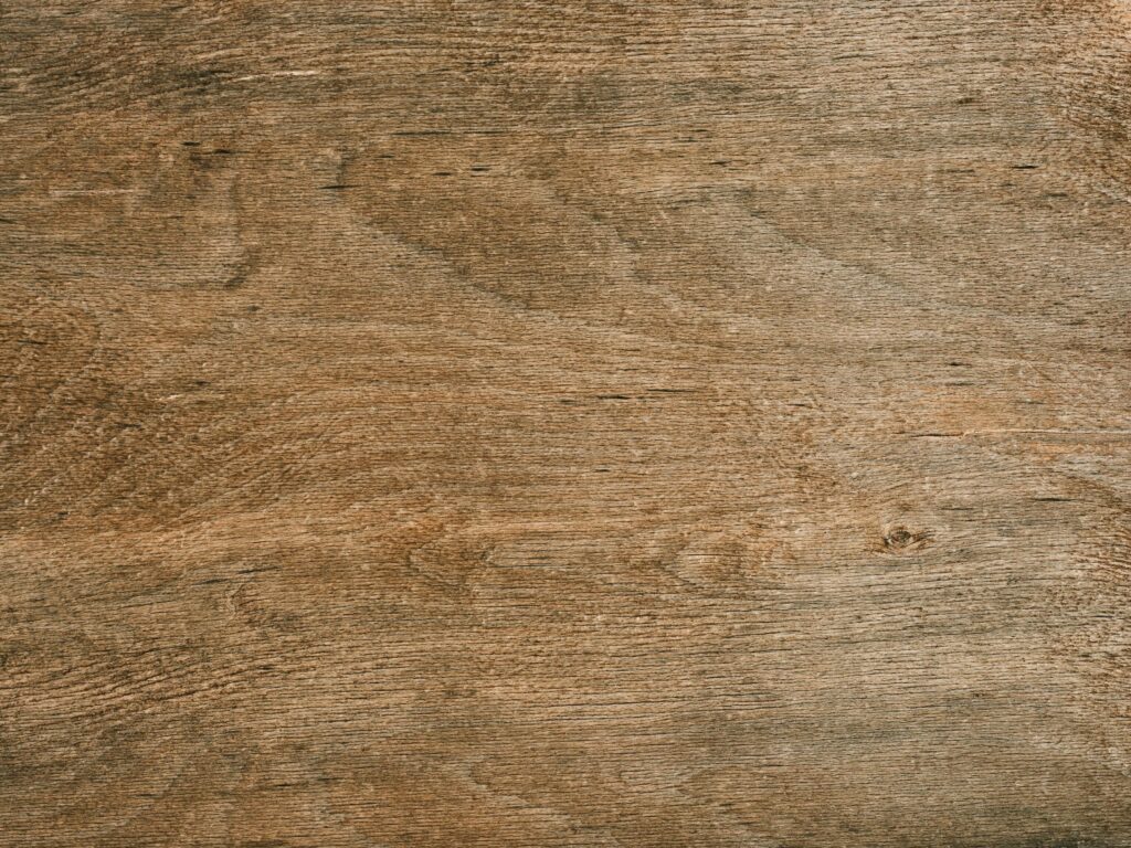 Detailed close-up of smooth brown wood grain texture for backgrounds and material designs.