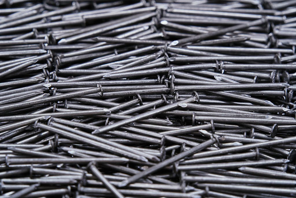 High-resolution image of numerous metal nails arranged closely together.
